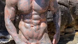 Hot Muslim guy covered in tattoos showing off his body and cock at the beach